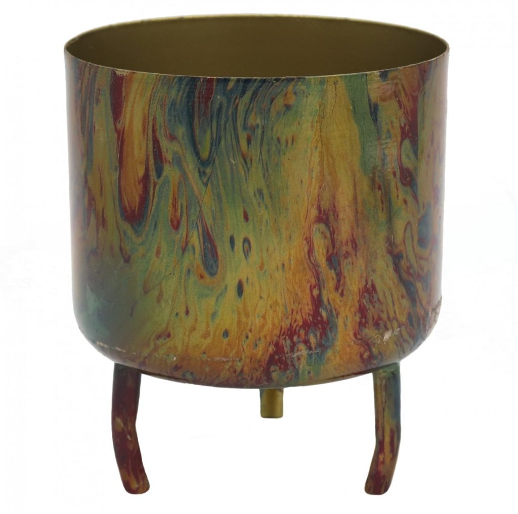 The Κασπώ Μεταλλικό is a cylindrical, three-legged metal planter featuring a marbled pattern in yellow, green, red, and blue, with a solid gold interior.